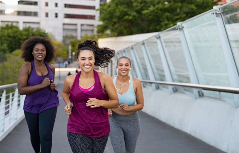 three women of color jogging outdoors