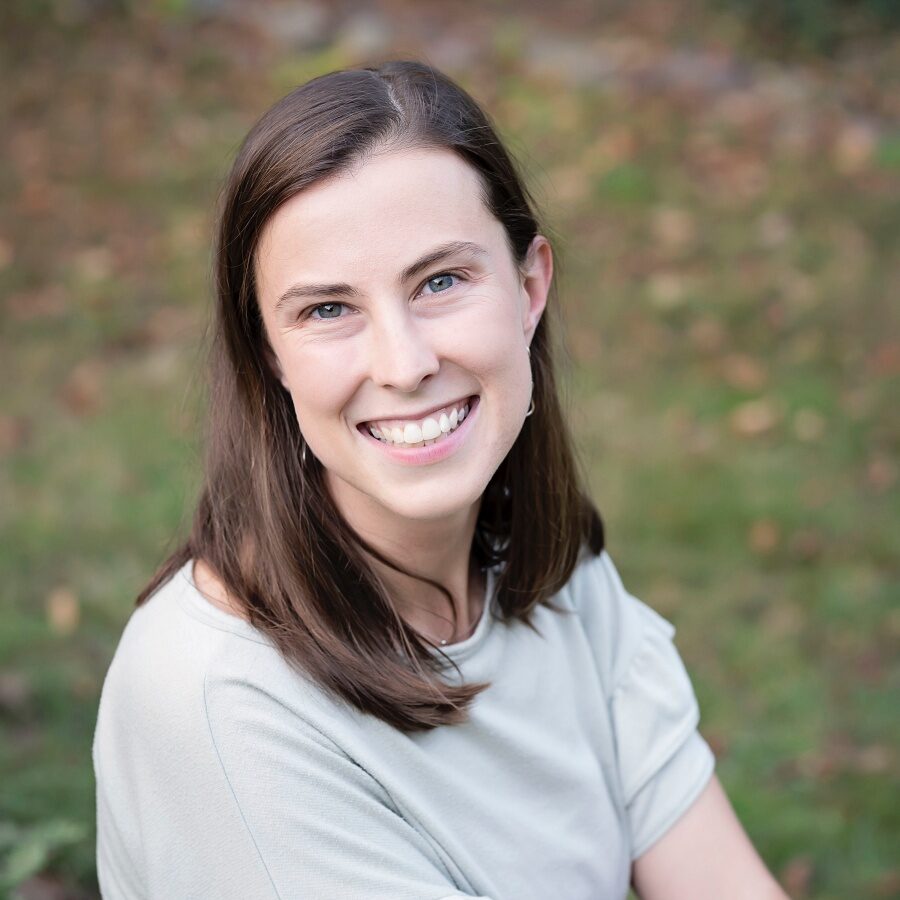 headshot of Erin Anderson, white woman with brown hair, wearing a tan top, photographed outdoors